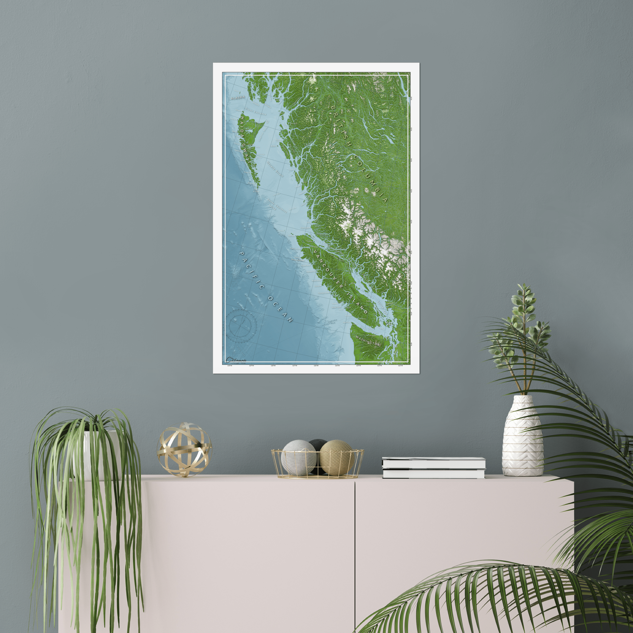 British Columbia map print positioned above bookshelf, displaying full provincial coastal bathymetry