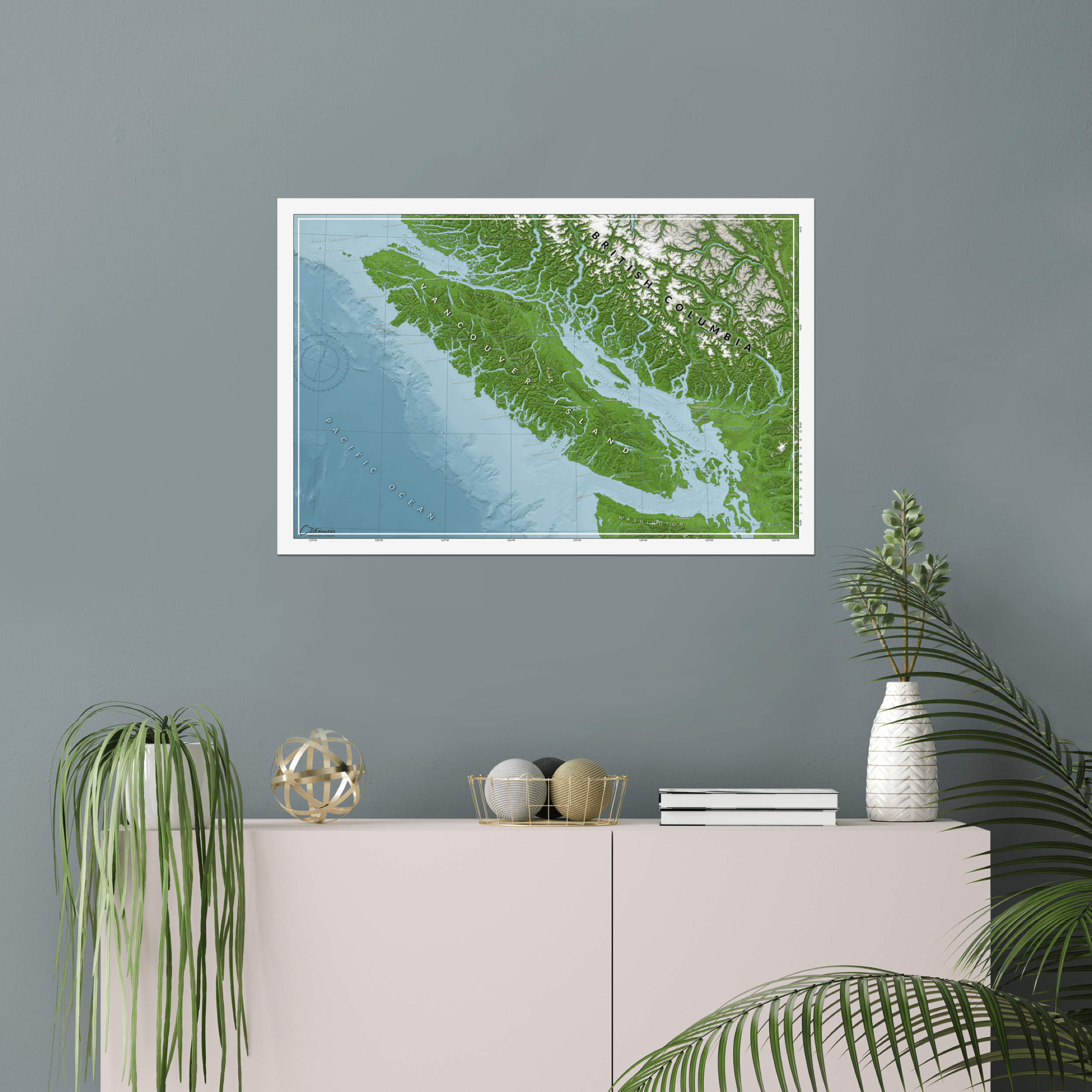 Vancouver Island map print above bookshelf on wall, showing full island topography and surrounding ocean bathymetry.
